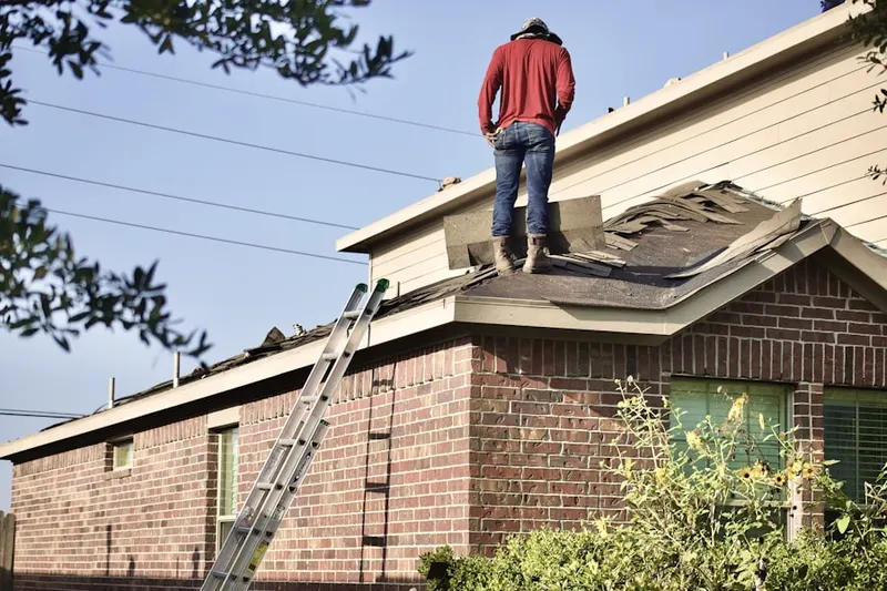 Professional roofer working on a residential roof in Le Jeune Gardens